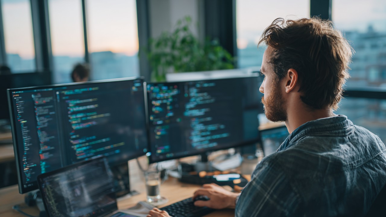 Focused web developer working on HTML code and SEO tools in a modern, naturally lit workspace, emphasizing hreflang tag implementation.