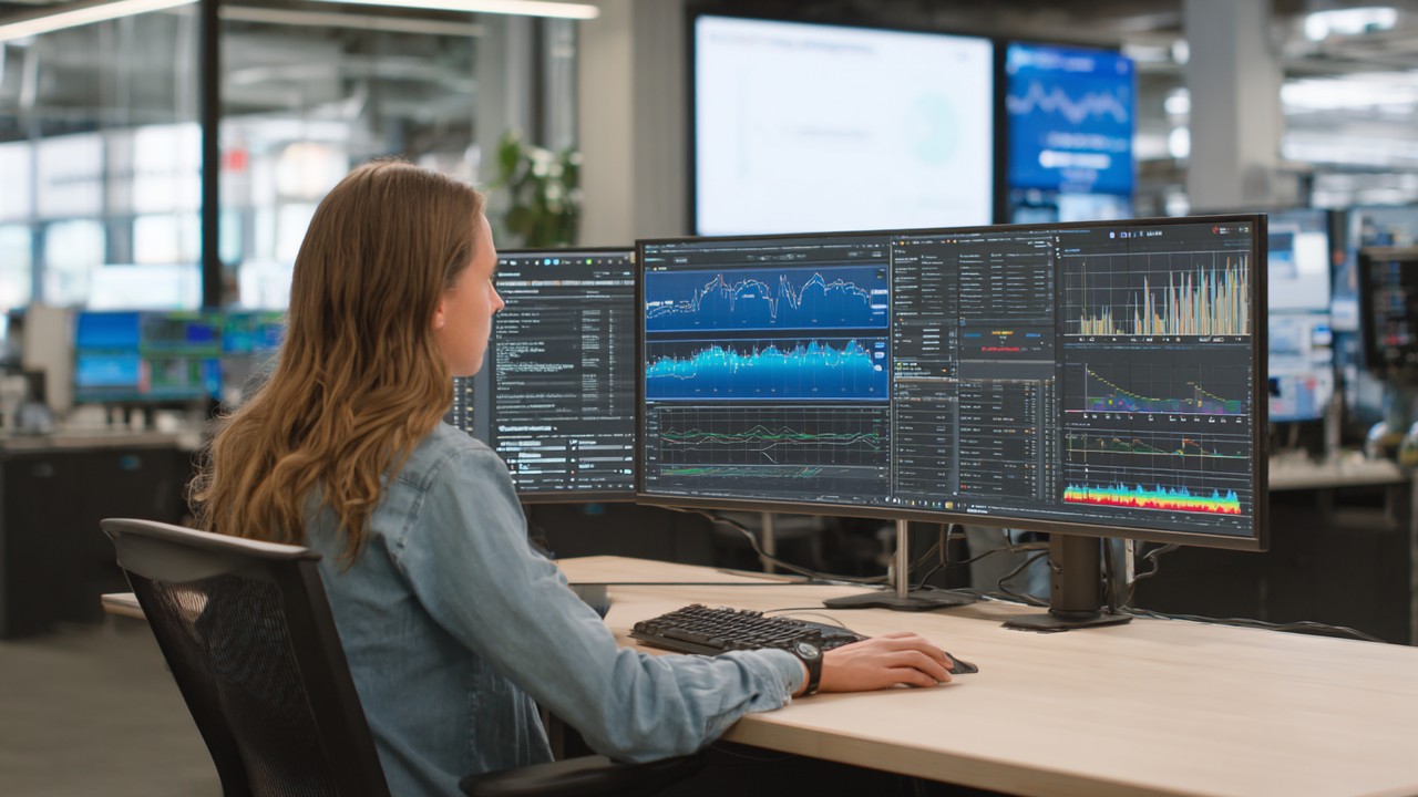 Technical SEO expert analyzing website analytics and URL parameters on multiple monitors in a high-tech office environment.